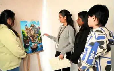 Fine arts students painting on canvas